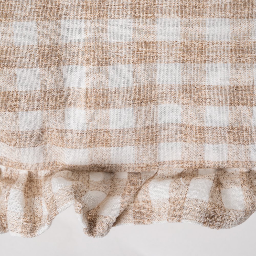 Close-up of ruffle edge detail on beige gingham cushion cover by Decor Petit