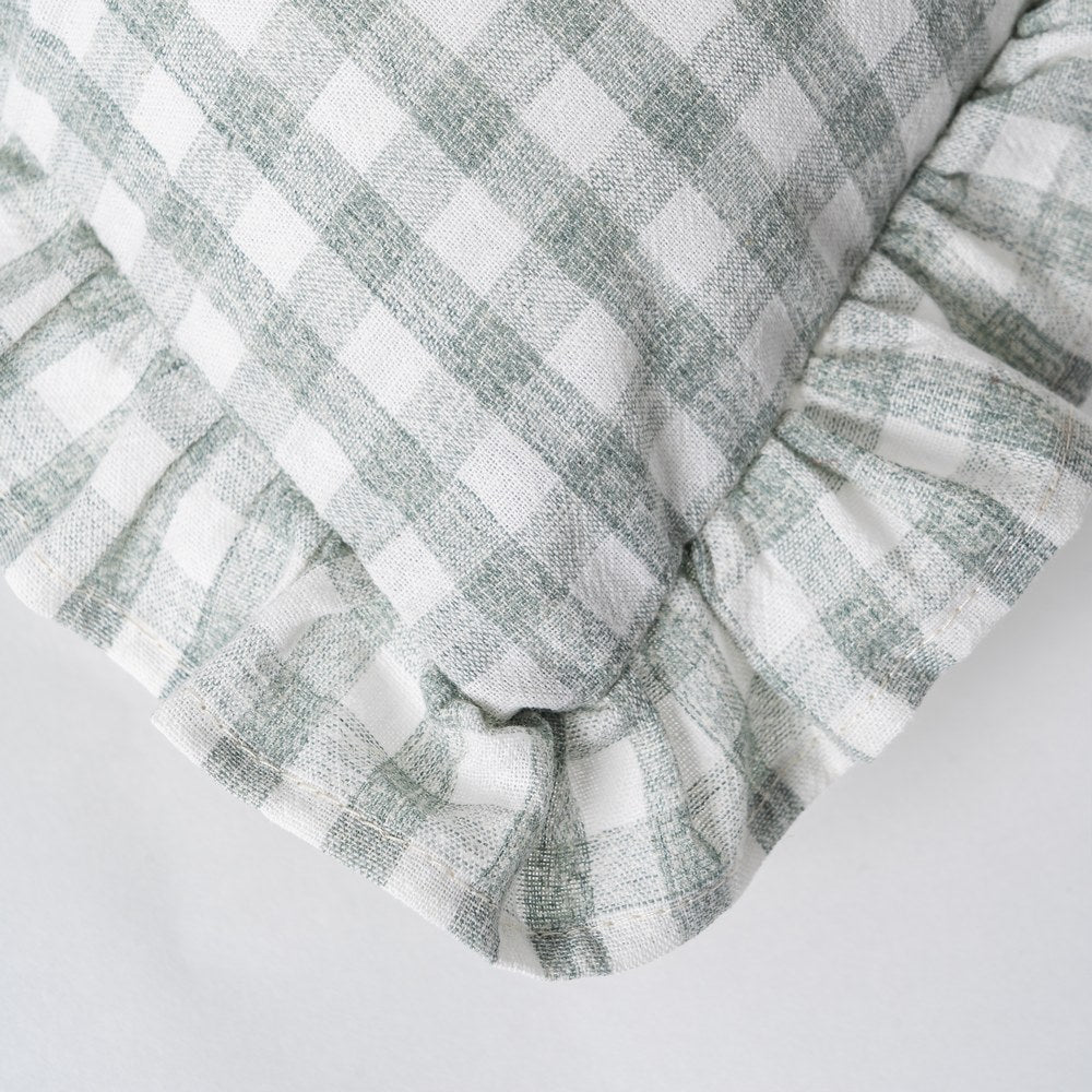 Stack of gray and white checkered fabric on a light gray background