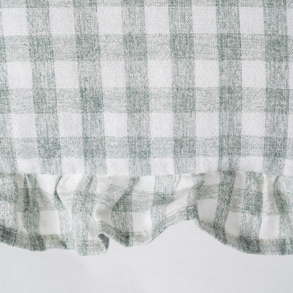 Checkered fabric with a ruffled edge on a white background