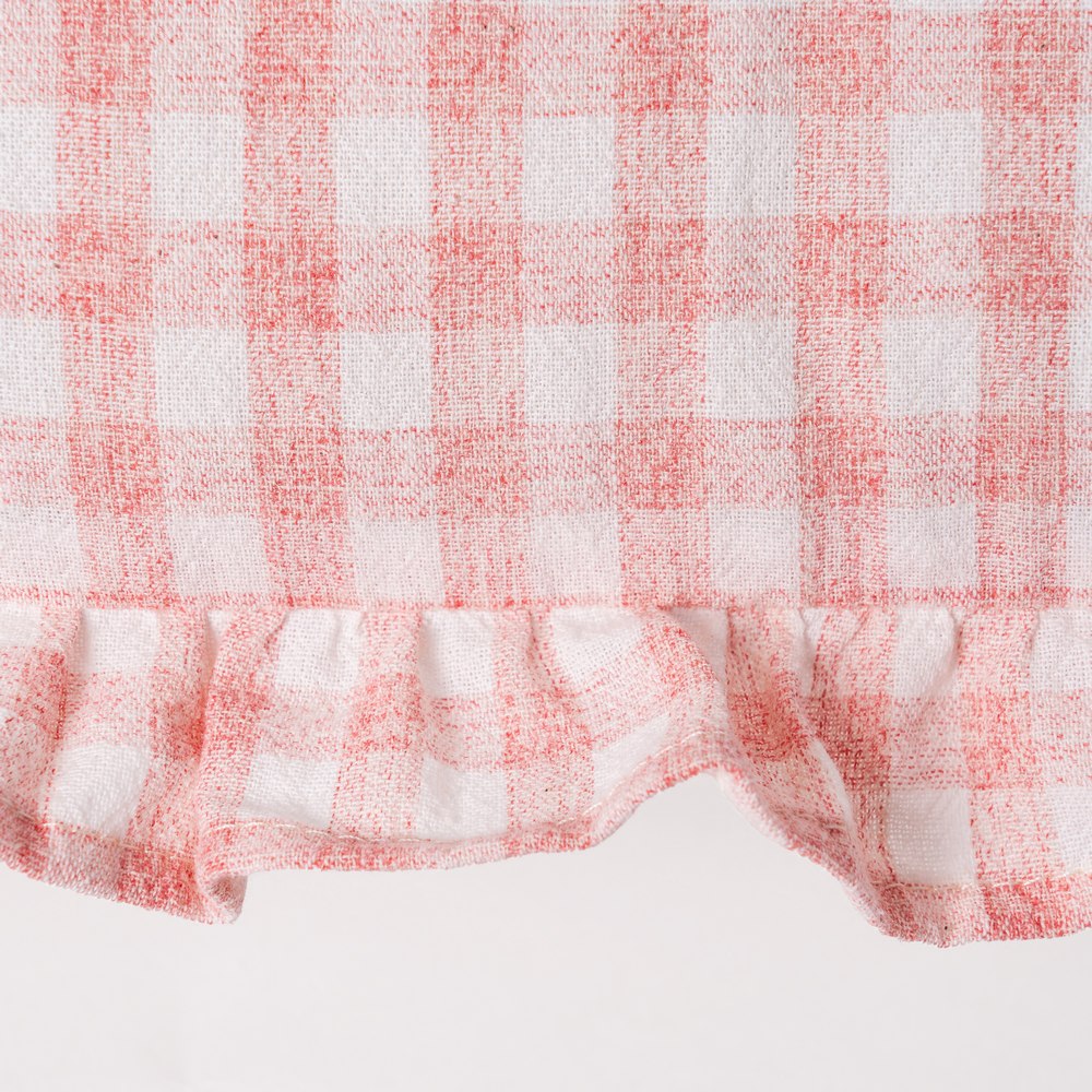 Close-up of ruffle edge detail on pink gingham cushion cover by Decor Petit