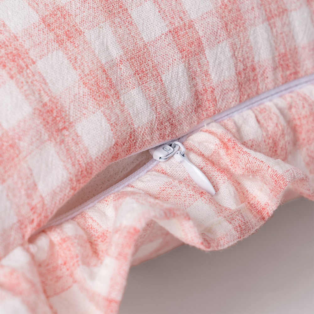 Close-up of ruffle edge detail on pink gingham cushion cover by Decor Petit