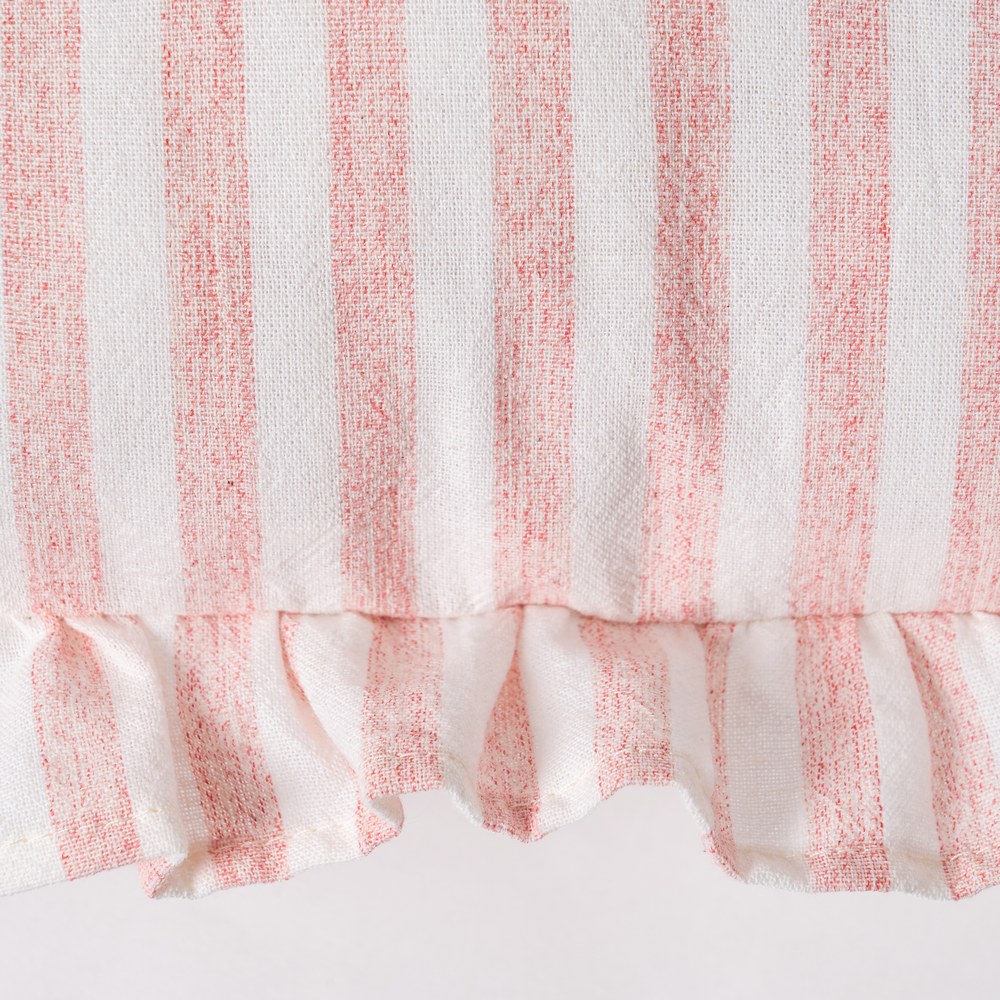 Close-up of ruffle edge detail on pink gingham cushion cover by Decor Petit